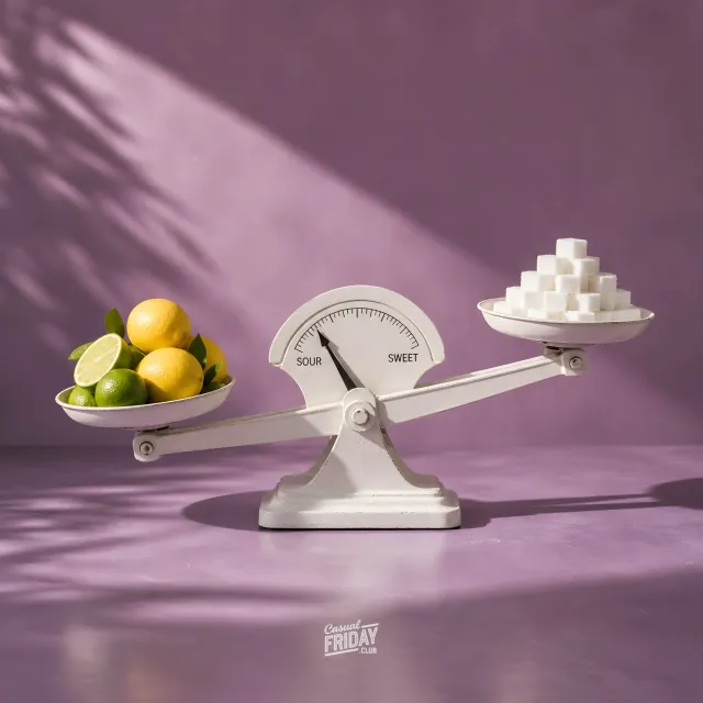 A balance scale with citrus on one side and sugar on the other